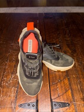 Steve Madden women’s Olive Camouflage Slip-On Sneakers with Orange Pull Tab